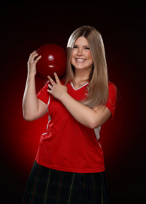 Evyn Dahlinger holding a red bowling ball